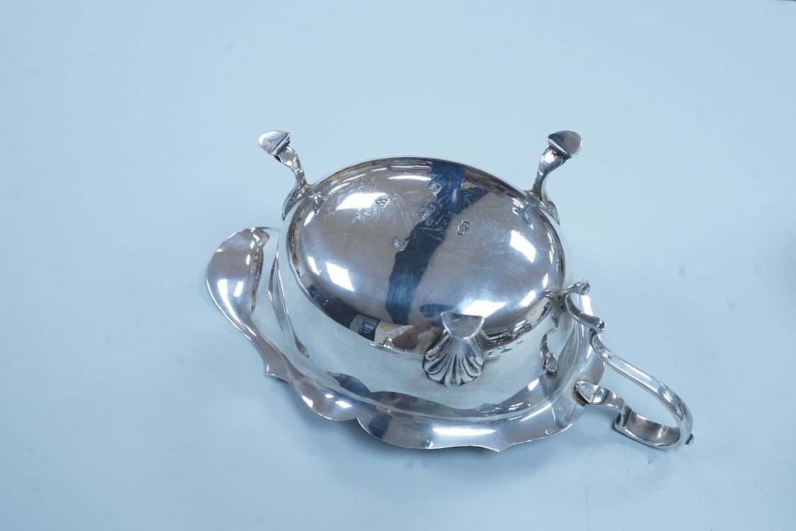 A pair of George VI silver sauceboats, with scroll handles, Stokes & Ireland, 1936, 16.2cm, together with four silver tennis related teaspoons (1 a.f.) and two small silver condiment spoons.